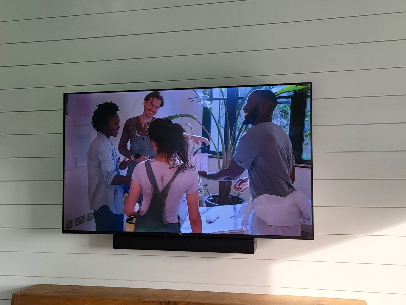 TV and soundbar mounted on shiplap wall